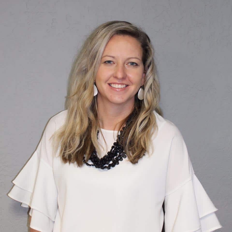 Woman smiling for a portrait against a gray background at Howard Payne University. | HPU